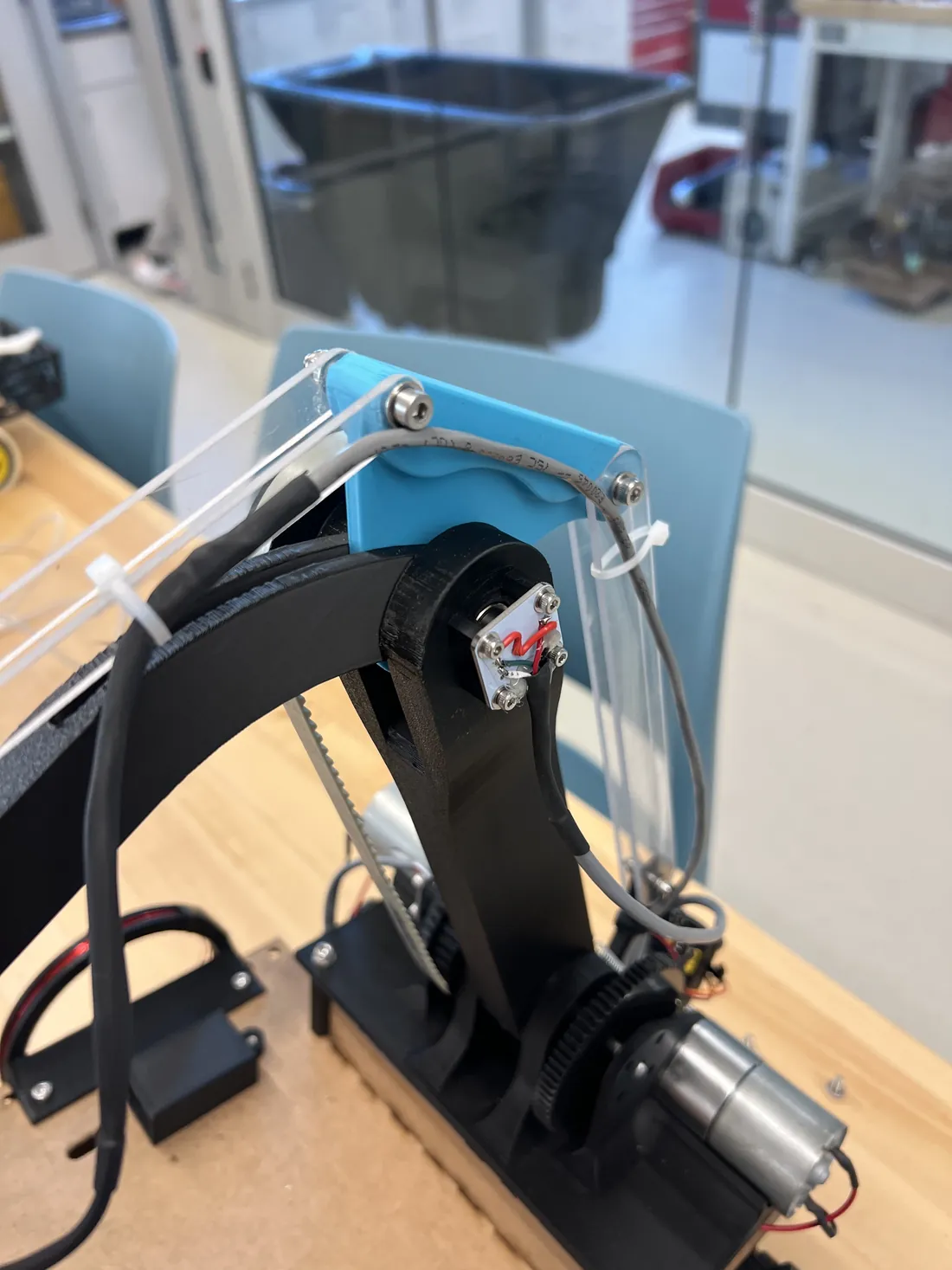 Close view of our robot's arm joint, belt drive, and encoder