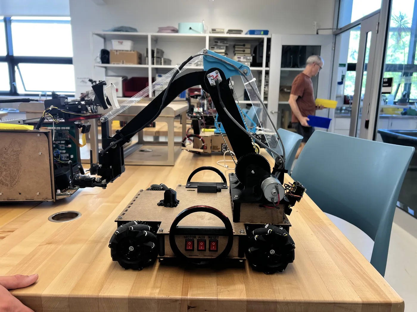 Front view of our robot's drivetrain and arm on a workbench